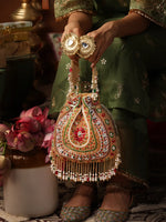 Decorative handbag with intricate designs held by a person in traditional attire.