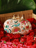 Decorative clutch bag with floral patterns on a bed of red roses