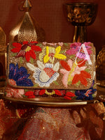 Decorative handbag with floral patterns on a textured surface