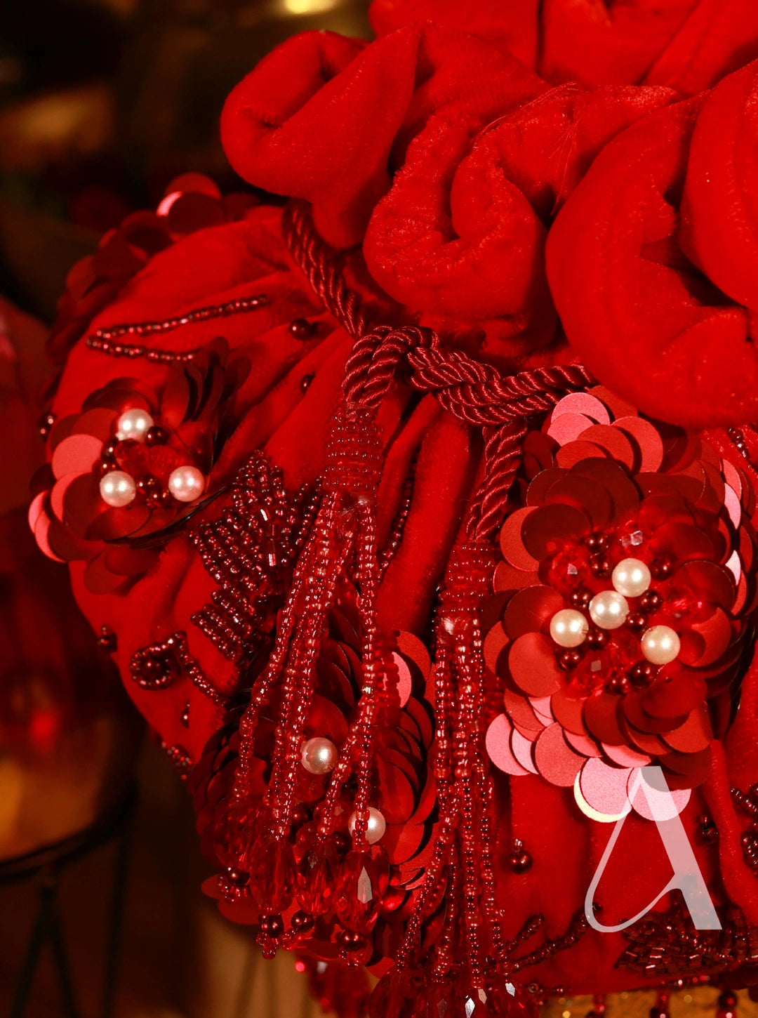 Decorative red hat with floral and tassel details