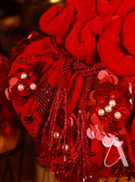 Decorative red hat with floral and tassel details