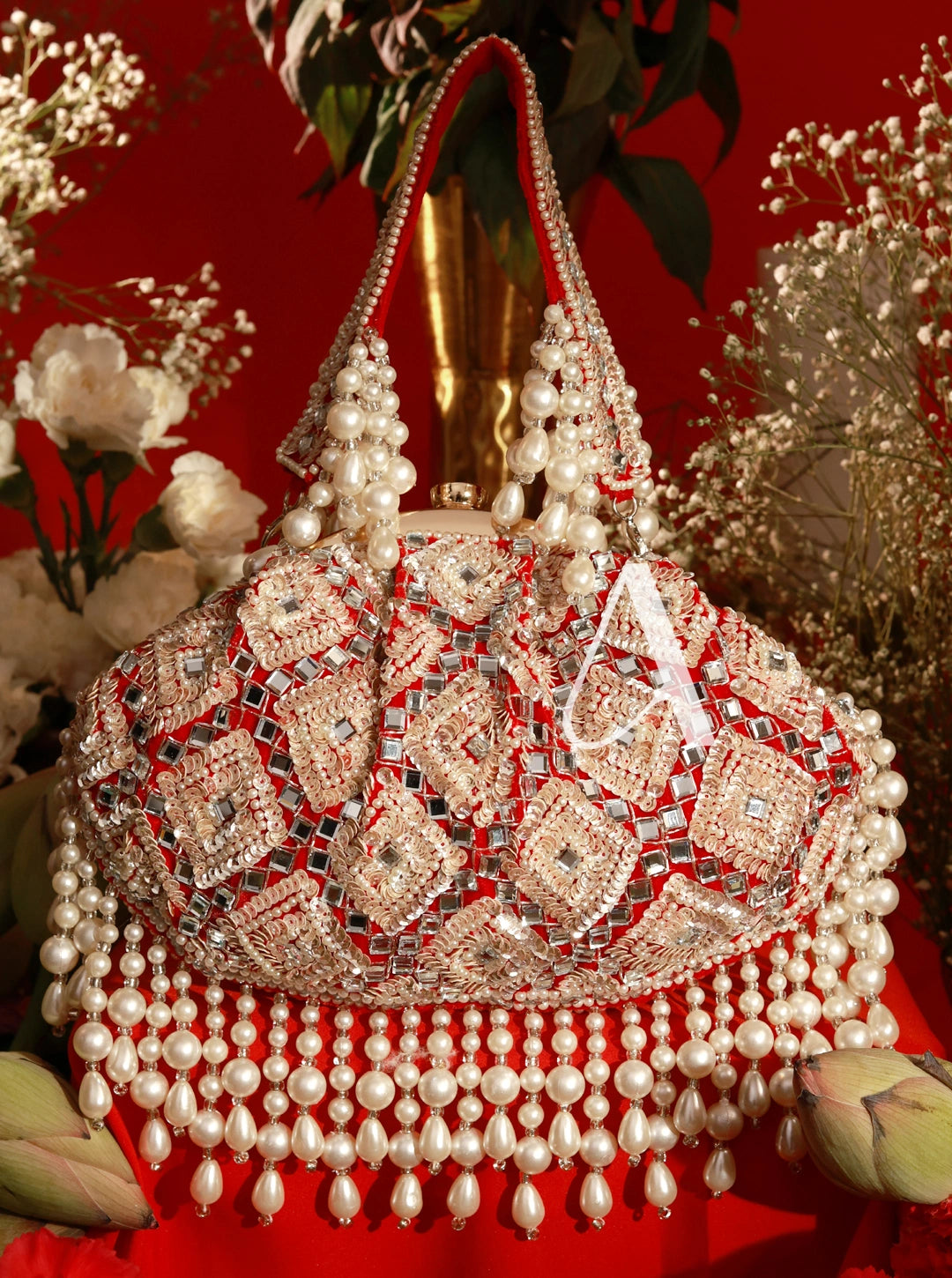 Decorative handbag with pearls and intricate patterns on a red background
