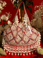 Decorative handbag with pearls and intricate patterns on a red background