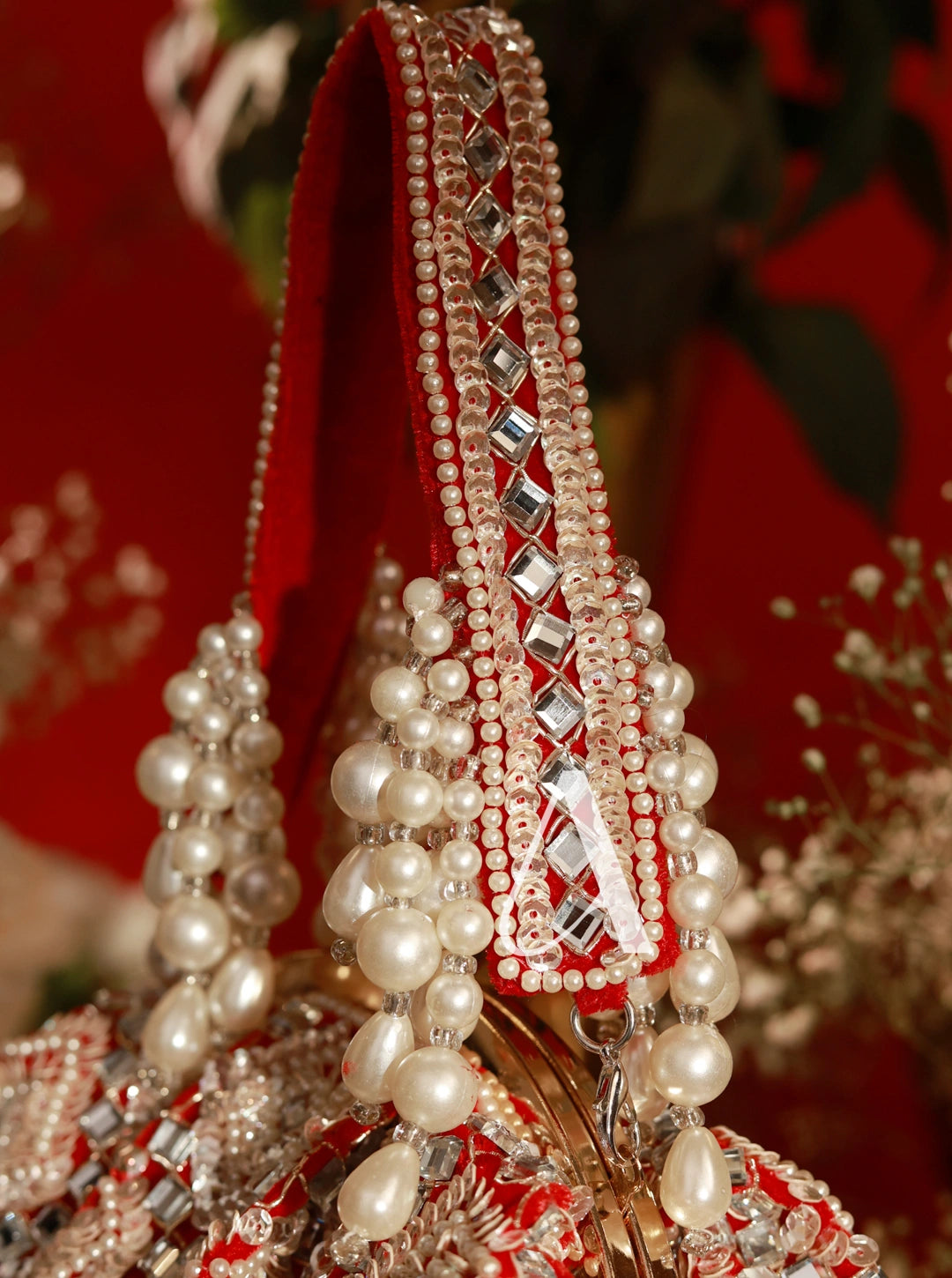 Decorative headpiece with pearls and crystals on a red background