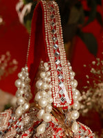 Decorative headpiece with pearls and crystals on a red background