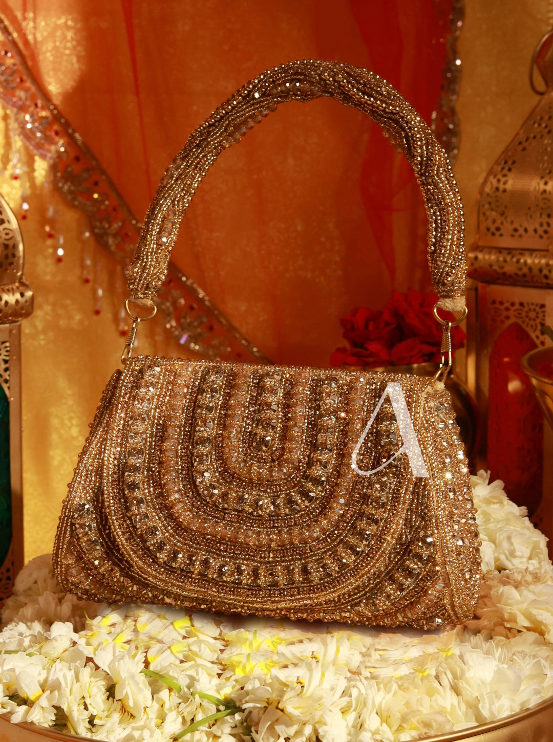 Decorative handbag with intricate patterns and a letter 'A' on a floral and ornate background