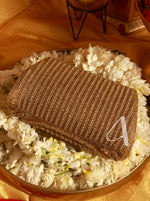Brown textured box with a white letter 'A' on a bed of white flowers.