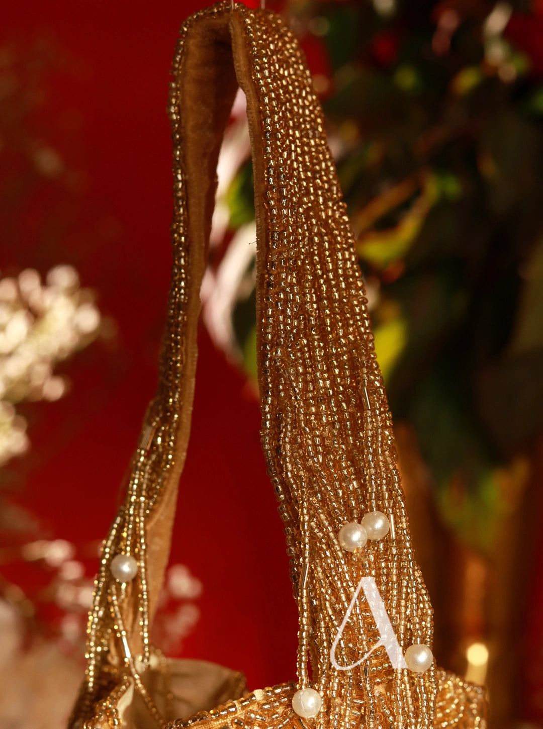 Decorative headband with gold beads and pearls on a blurred background