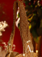 Decorative headband with gold beads and pearls on a blurred background