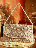 Decorative handbag with intricate patterns on a floral and lantern background