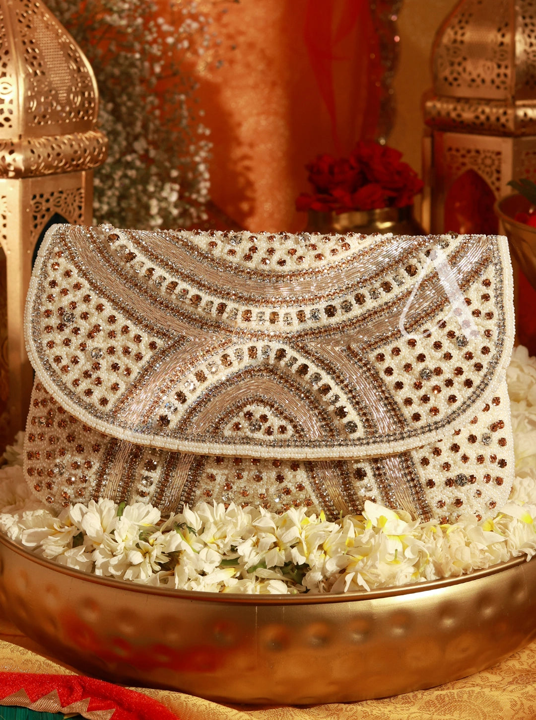 Decorative clutch with intricate patterns on a floral arrangement, set against a warm-toned background.
