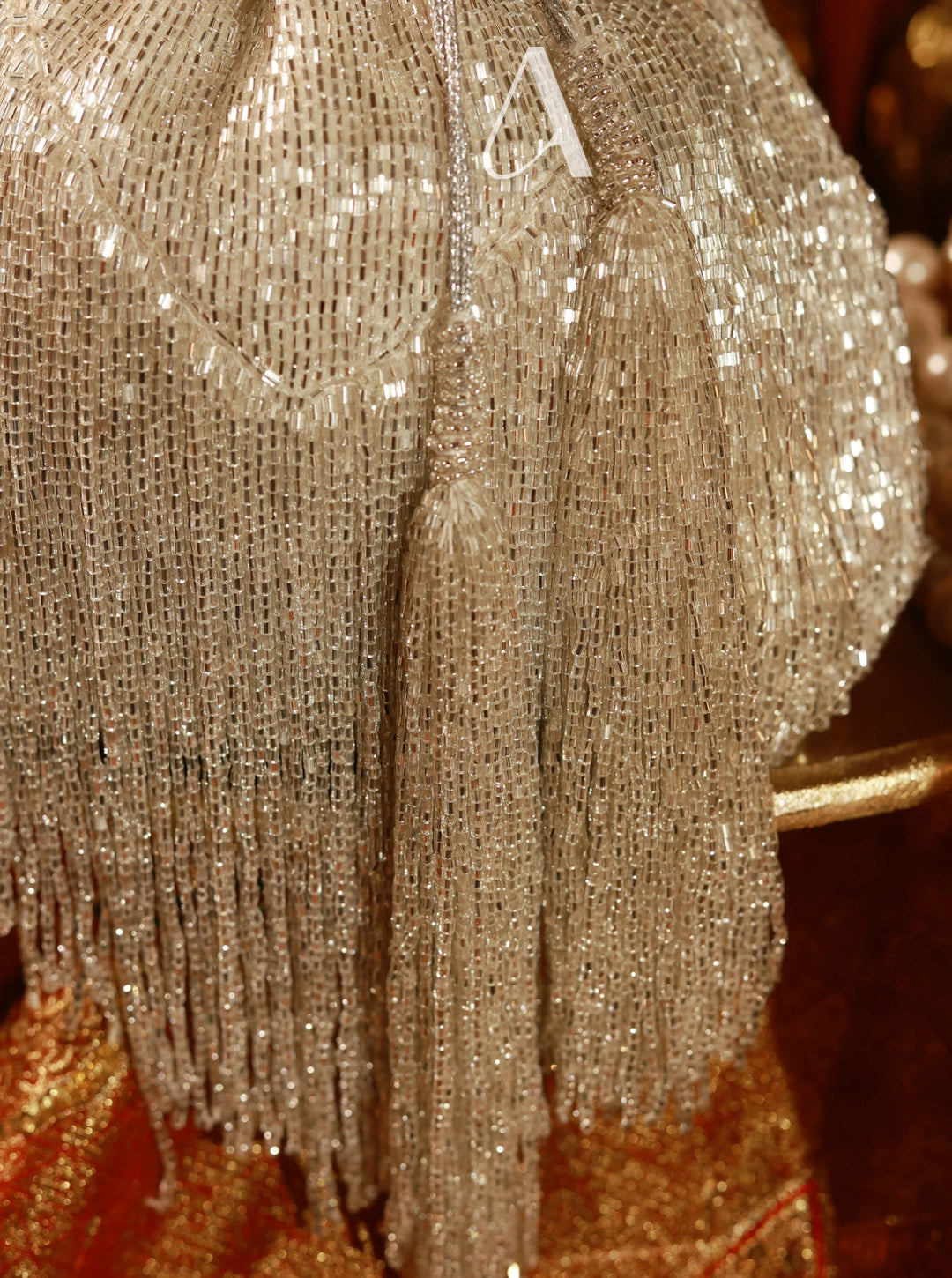 Close-up of a glittery, textured surface with a brand logo.