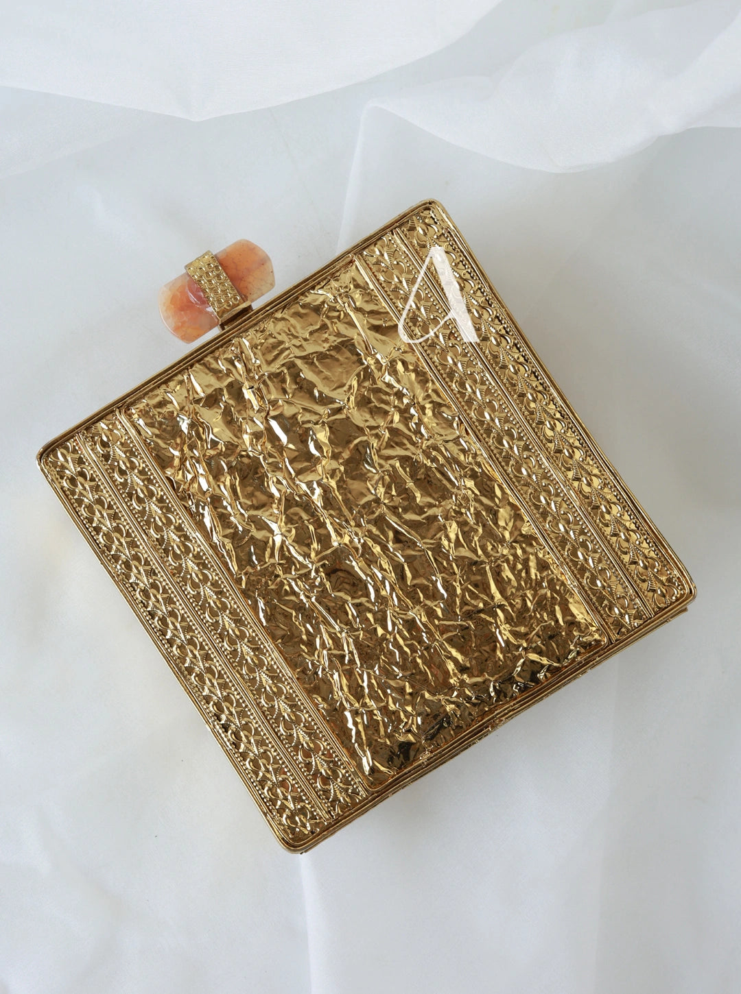 Gold embossed clutch bag on a white background