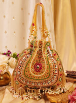 Decorative handbag with intricate designs and embellishments on a floral background