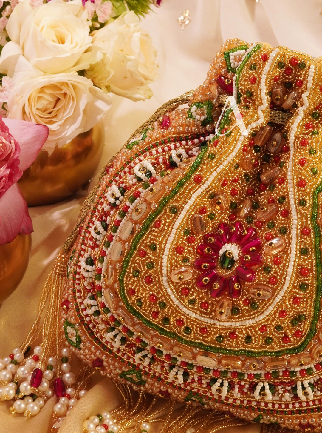 Decorative handbag with intricate patterns and embellishments on a floral background