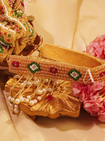 Gold bracelet with decorative elements on a floral background