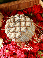 Decorative handbag with floral patterns on a bed of red flowers