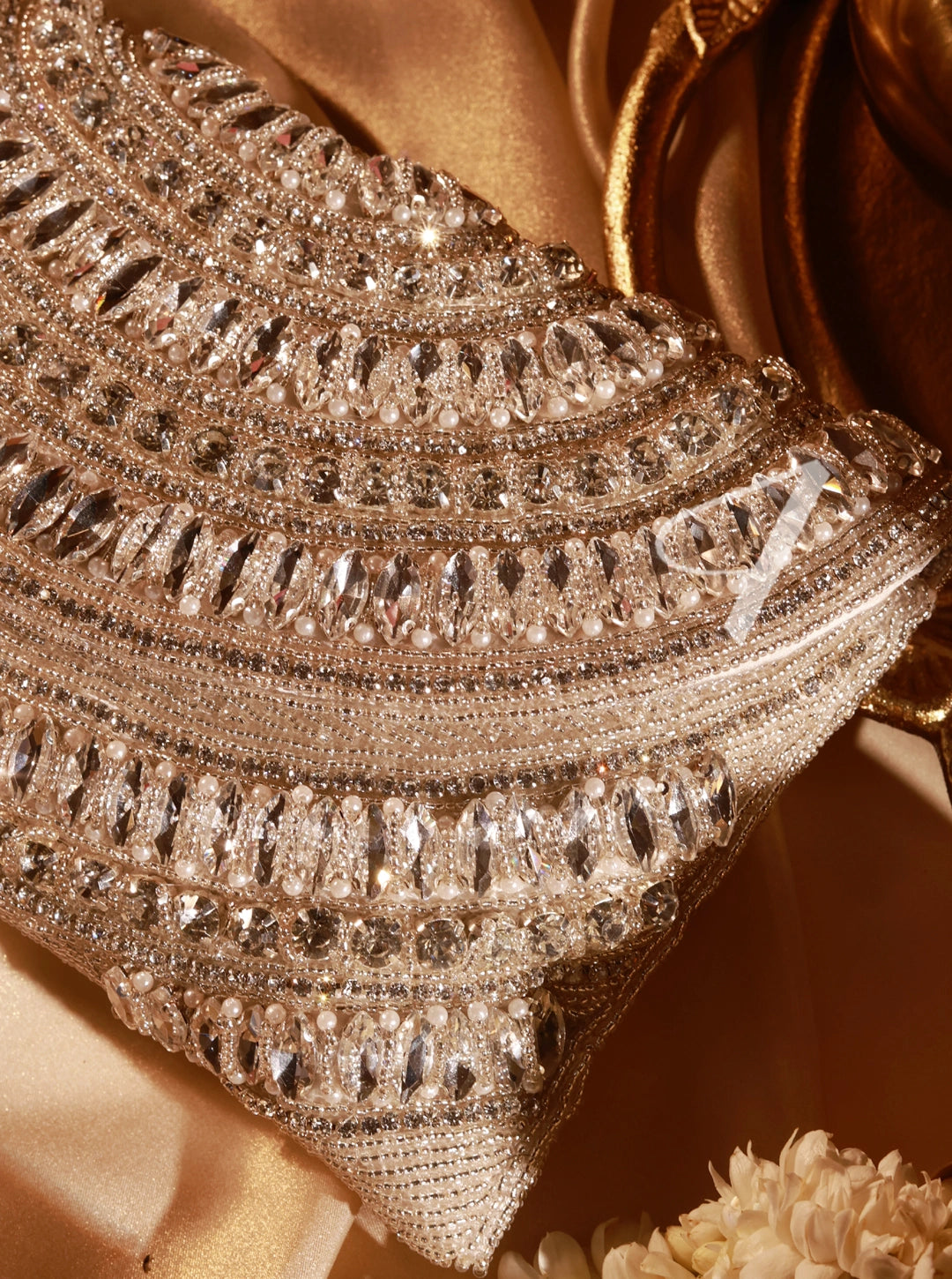 Close-up of a sparkling, ornate clutch bag with intricate detailing.
