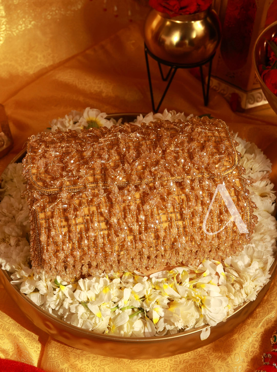 Decorative cake with gold and white elements on a table