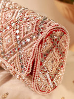 Decorative clutch with intricate beadwork and sequins on a neutral background