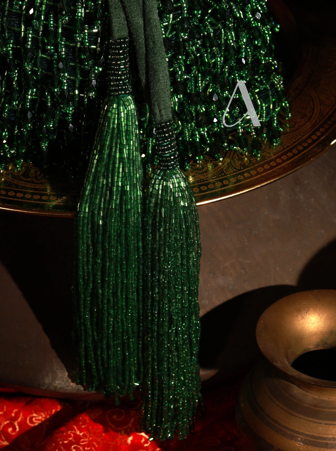 Close-up of a green beaded tassel with a blurred background