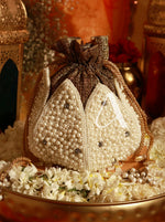 Decorative bag with pearls and a letter 'A' on a floral background