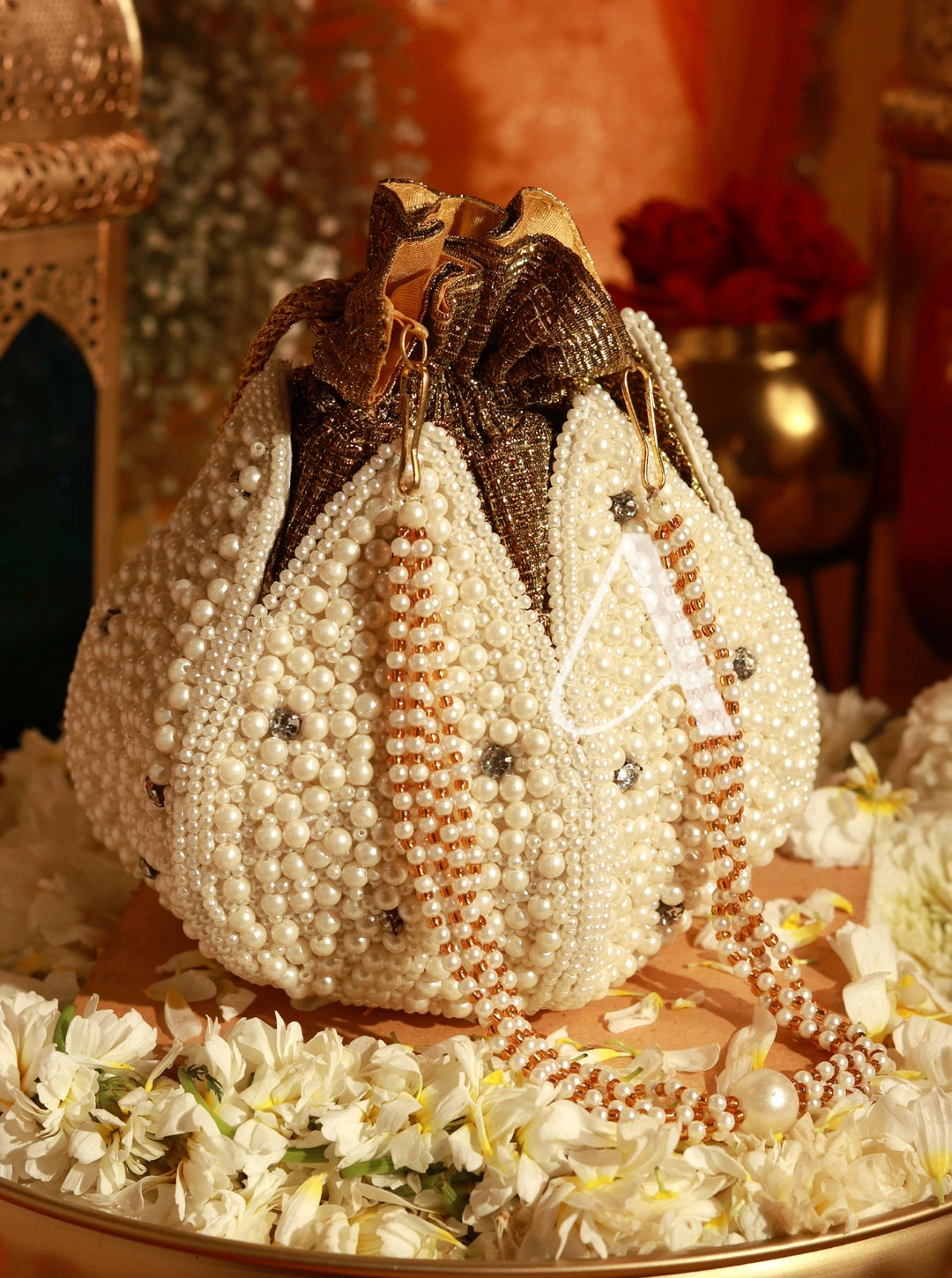 Decorative bag made of pearls and beads on a floral background