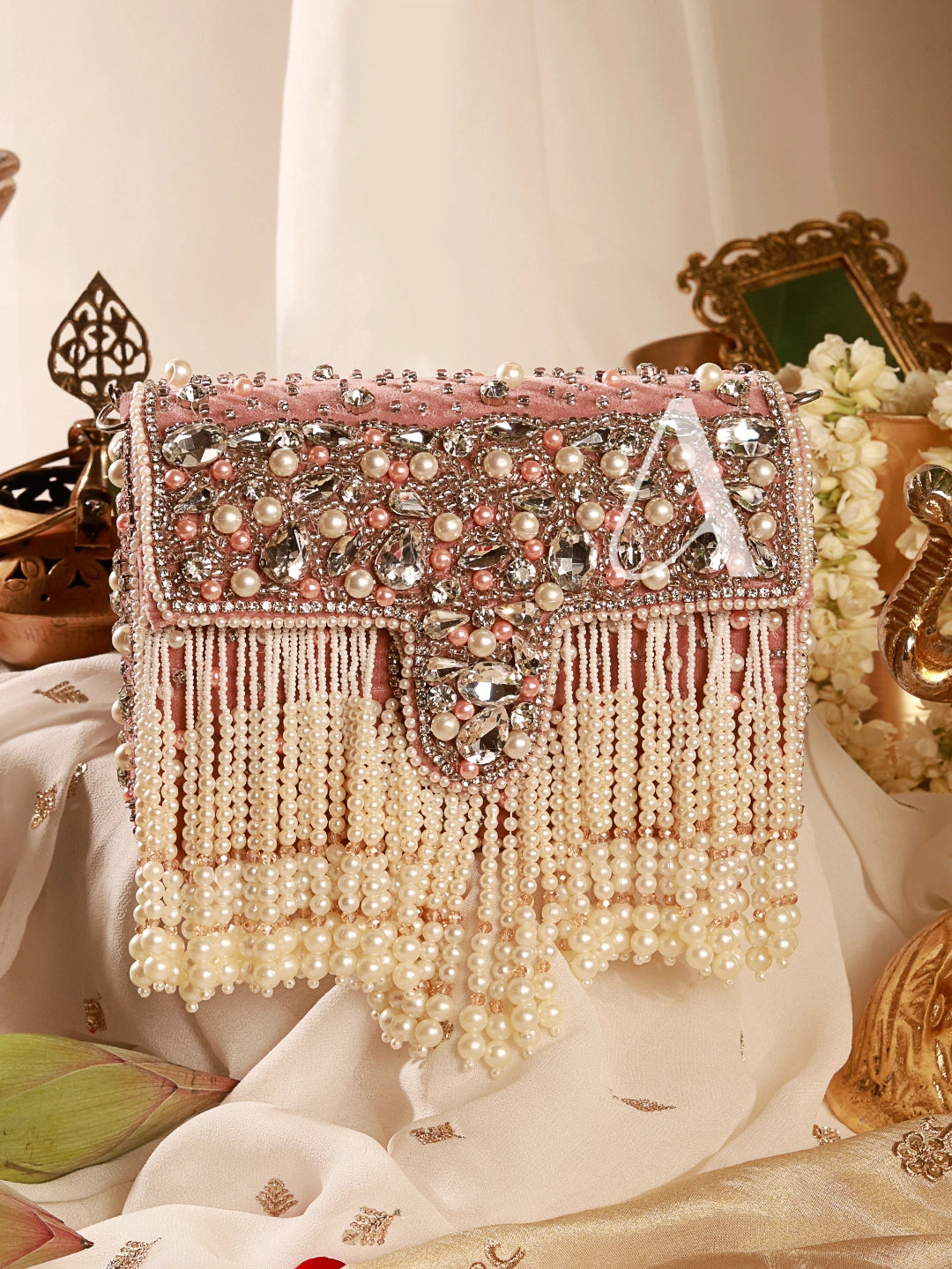 Decorative handbag with pearls and embellishments on a decorative background