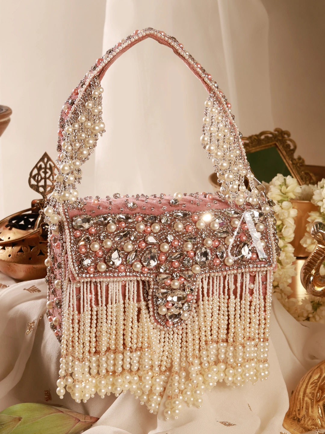 Decorative handbag with pearls and crystals on a white background