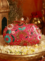 Decorative pink handbag with floral patterns on a decorative surface