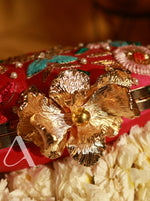 Decorative item with gold flowers on a red background