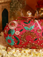 Decorative clutch bag with floral embroidery on a floral surface