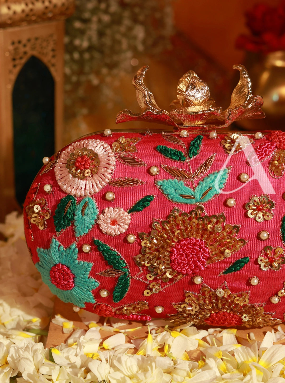 Decorative clutch bag with floral embroidery on a floral surface
