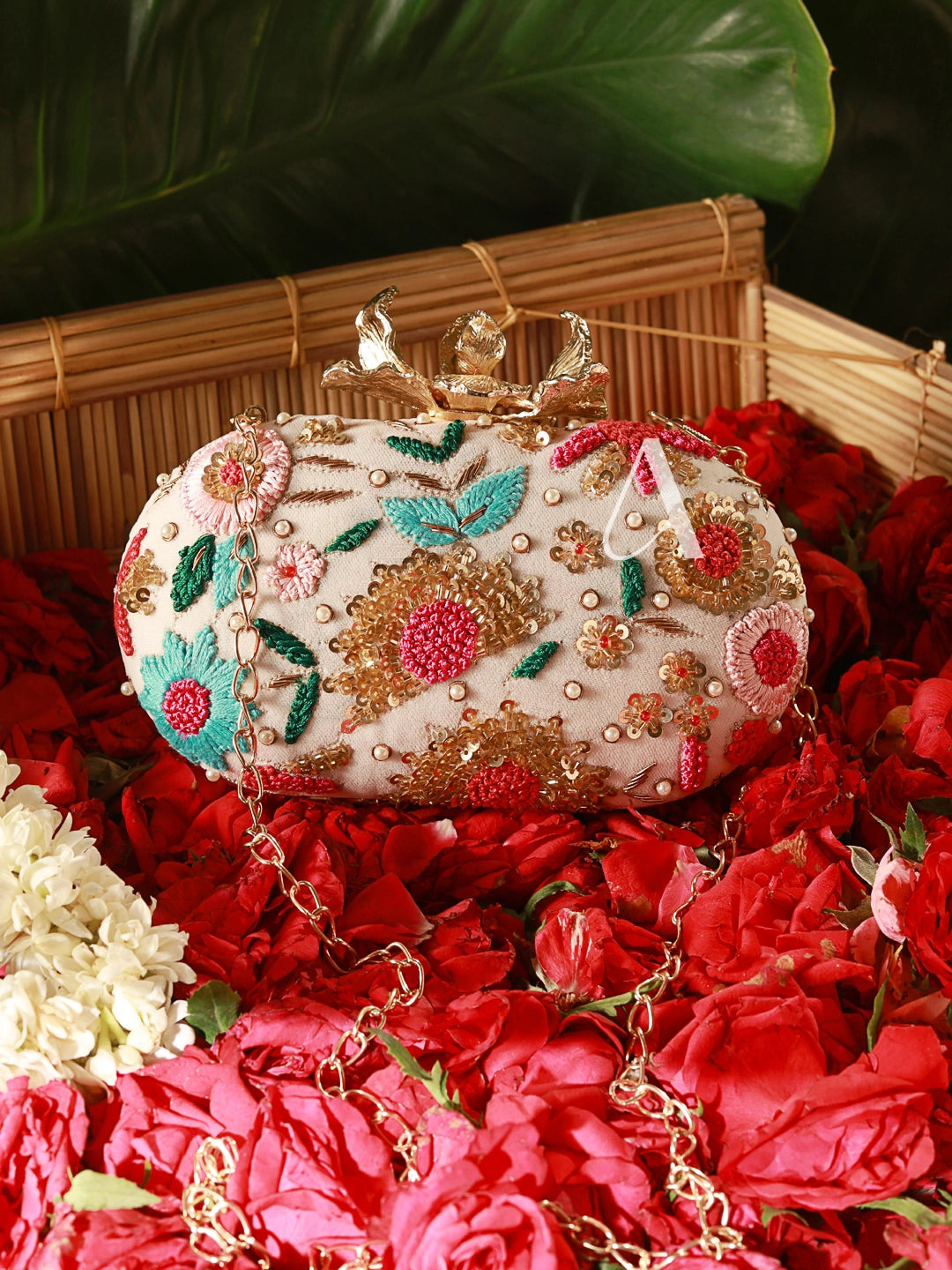 Decorative handbag with floral patterns on a bed of red flowers