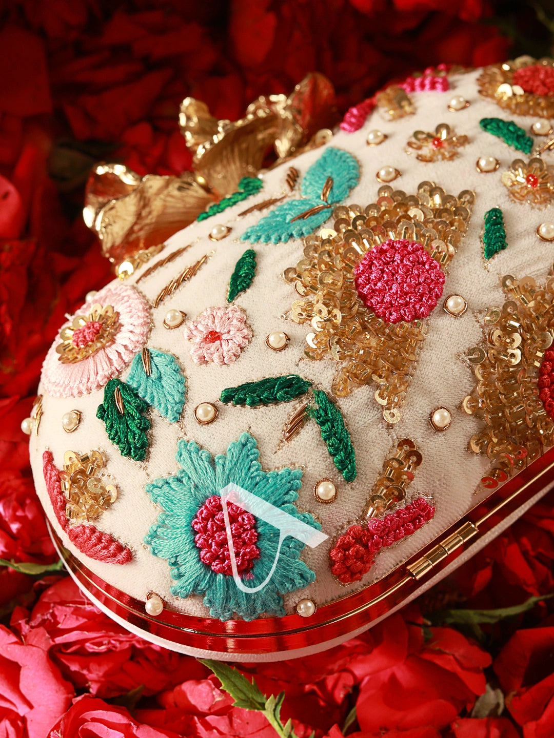 Decorative compact mirror with floral patterns on a red floral background