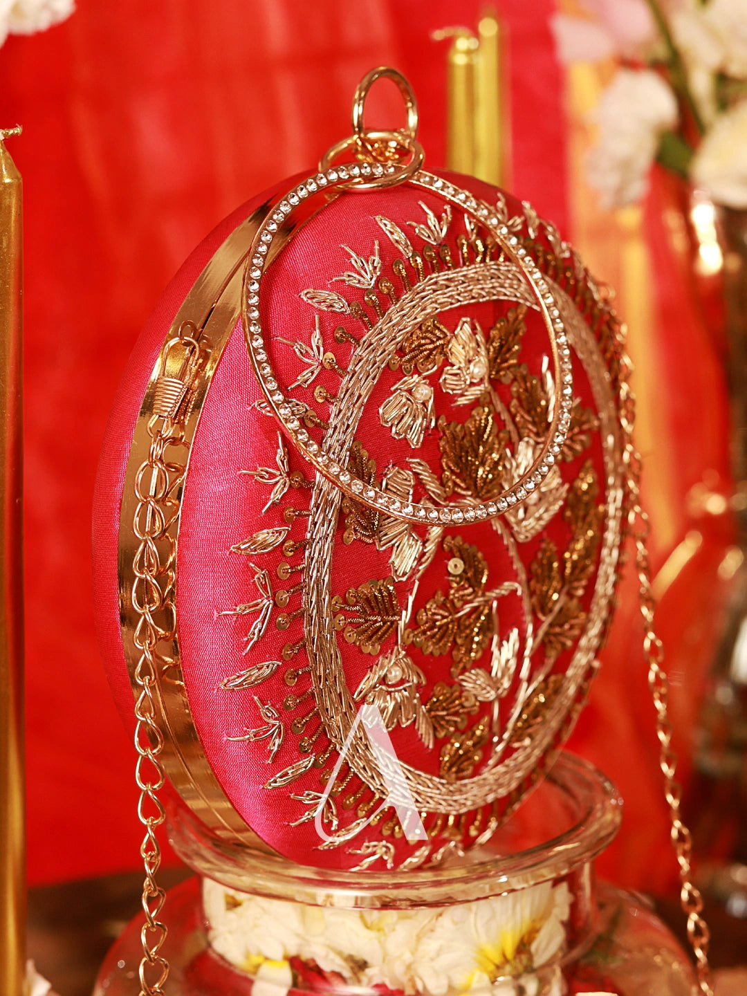 Decorative round object with gold embroidery on a red background