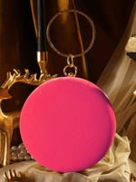 Pink round keychain with gold ring on a decorative background