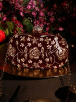 Decorative handbag with floral patterns on a dark background