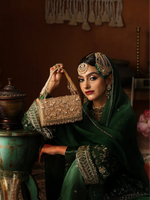Woman in traditional attire holding a decorative handbag in an indoor setting.