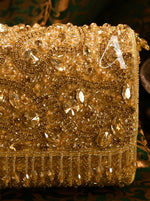 Gold embellished clutch bag with intricate designs