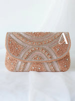 Elegant clutch bag with intricate patterns and embellishments on a white background