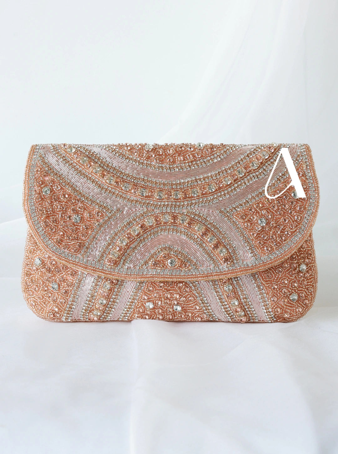 Elegant clutch bag with intricate patterns and embellishments on a white background