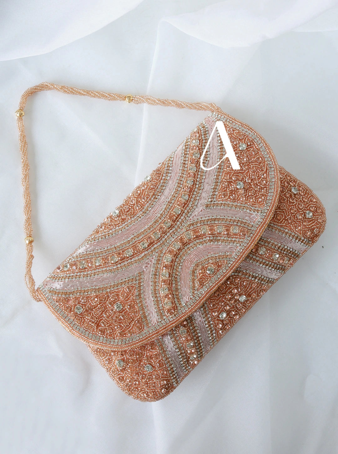 Beaded clutch bag with intricate patterns on a white background