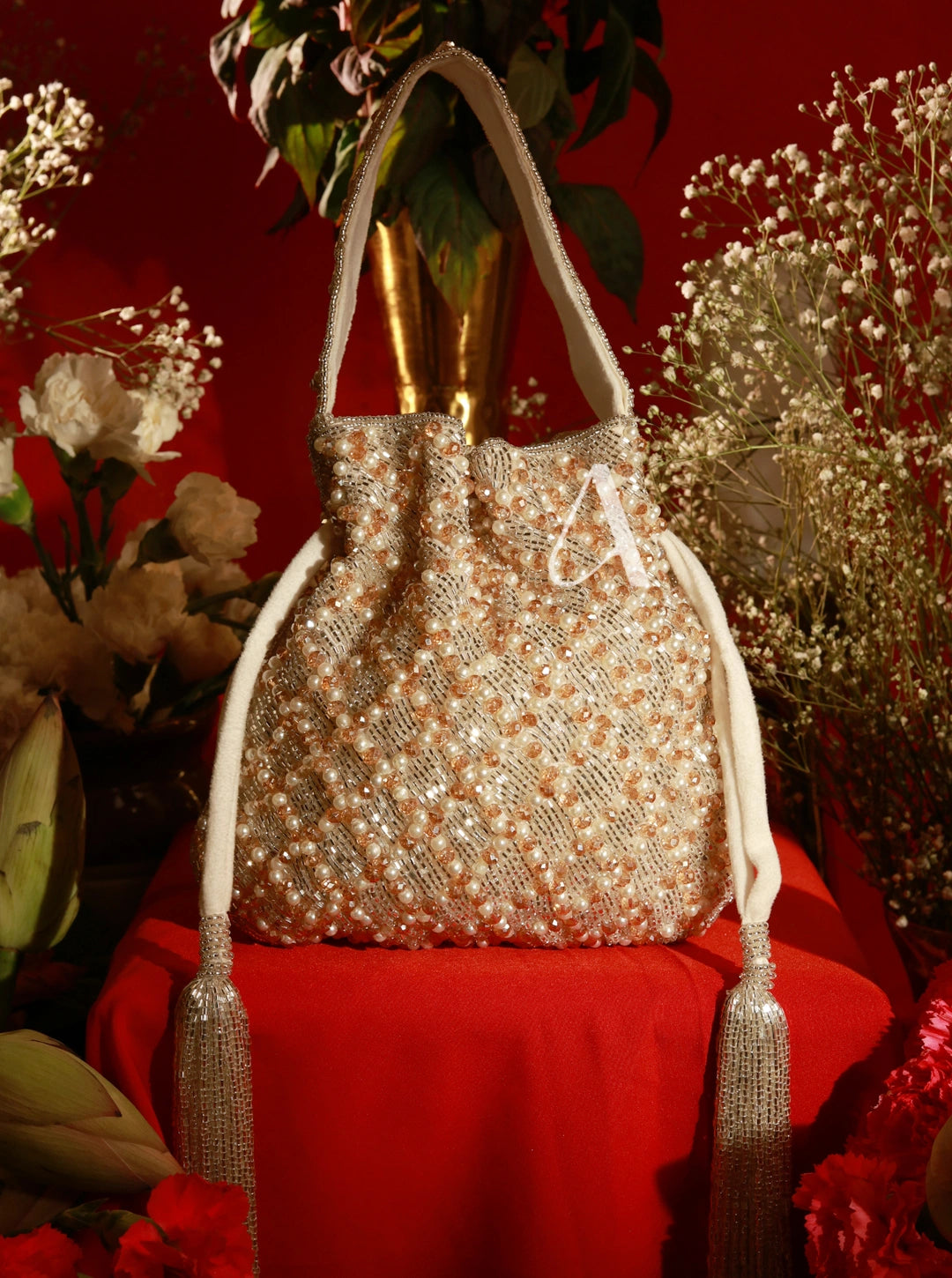 Decorative handbag with floral design on a red background