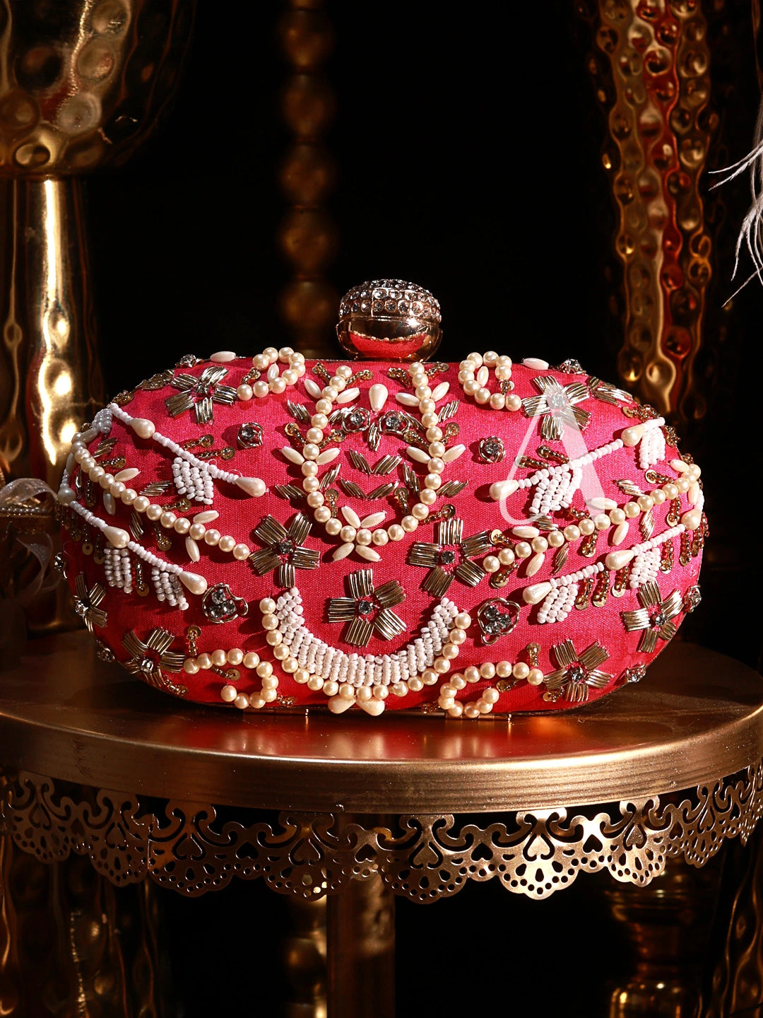 Decorative pink box with jewelry on a ornate table
