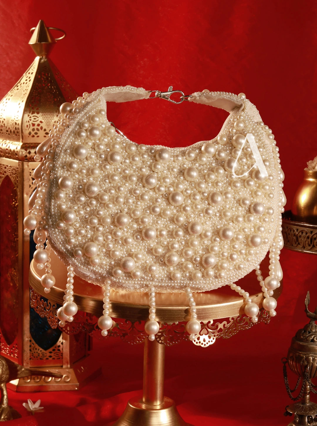 Pearl-handled handbag on a decorative stand with a red background