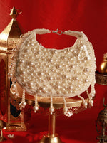 Pearl-handled handbag on a decorative stand with a red background