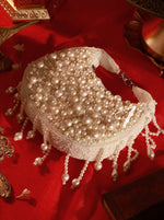 Pearl-handled handbag on a red background