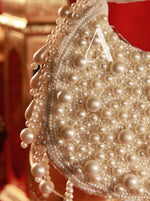 Pearl-encrusted handbag with a blurred background
