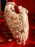 Pearl-handled handbag with decorative elements on a red background